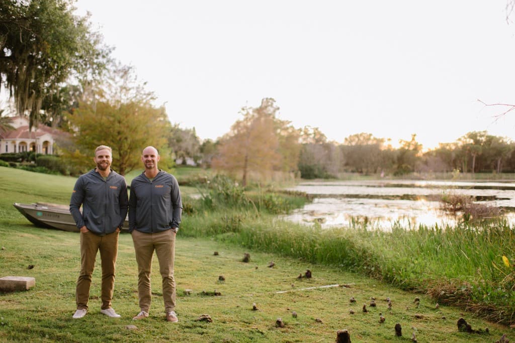Panther Pest Control owners at a Central Florida lakefront sunset